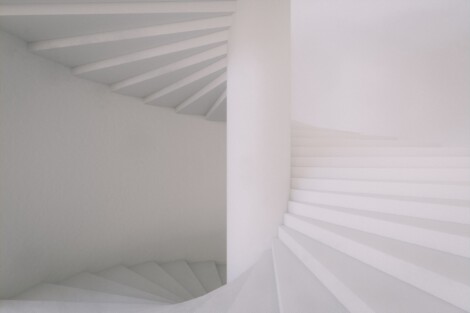 white winding stairs with column in the middle